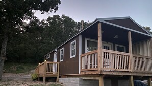 A two-story cabin with a wooden deck and a covered porch. - Cozy Lakeview Cabin, Boat Parking, Breathtaking Lake View, One Hour from Tulsa  (Afton)