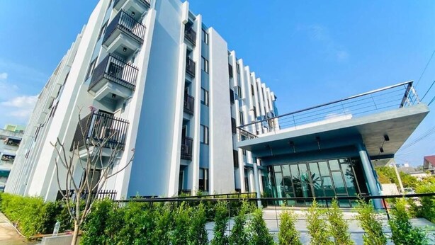 A modern multi-story building with balconies and a glass facade. - ABIZZ Hotel KwanPhayao (Phayao)