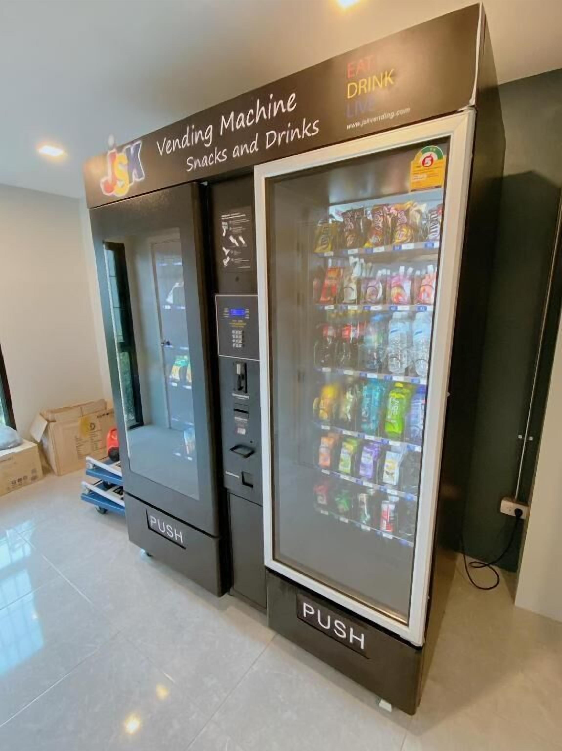 A vending machine labeled "Vending Machine Snacks and Drinks" with a "PUSH" button and a display screen.