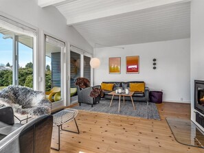 A modern living room with a sofa, coffee table, and a fireplace. - "Allaine" - 500m from the sea by Interhome (Væggerløse)