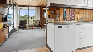 A modern kitchen with white cabinets, a granite countertop, and a built-in dishwasher. - "Sulo" - 1.4km from the sea by Interhome (Thisted)