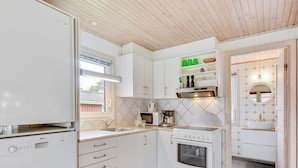 A modern kitchen with white cabinets, a Bosch refrigerator, a built-in oven, and a window with blinds. - "Anline" - 900m to the fjord by Interhome (Tarm)