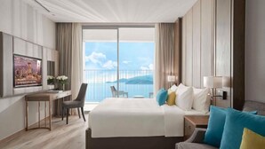 A hotel room with a large bed, a desk, a chair, and a TV. - Zahoo house in Panorama Nha Trang  (Nha Trang)