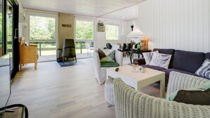 A spacious living area with a high ceiling, a sofa set, a dining table, and a grill. - "Angantir" - 700m to the fjord by Interhome (Løgstør)