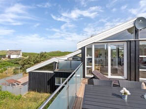 A modern house with a glass conservatory, a deck, and a satellite dish. - "Swerting" - 230m from the sea by Interhome (Saltum)