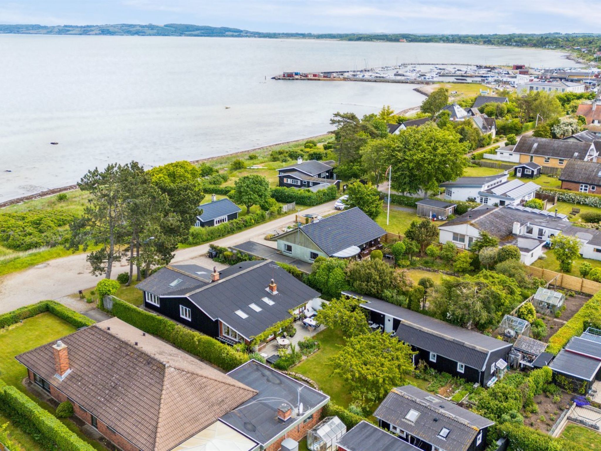 A residential area with houses, a marina, and a large body of water.