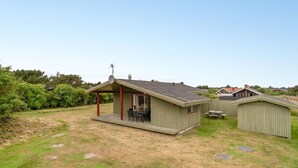 A small, single-story building with a covered patio area.