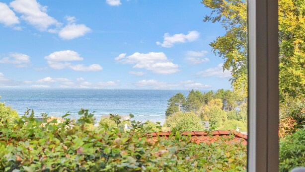 A view from a window overlooking a body of water, with greenery and a building in the foreground. - "Ludewiga" - 350m from the sea by Interhome (Glesborg)