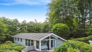 A small, single-story house with a sloped roof, surrounded by dense greenery. - "Ludewiga" - 350m from the sea by Interhome (Glesborg)