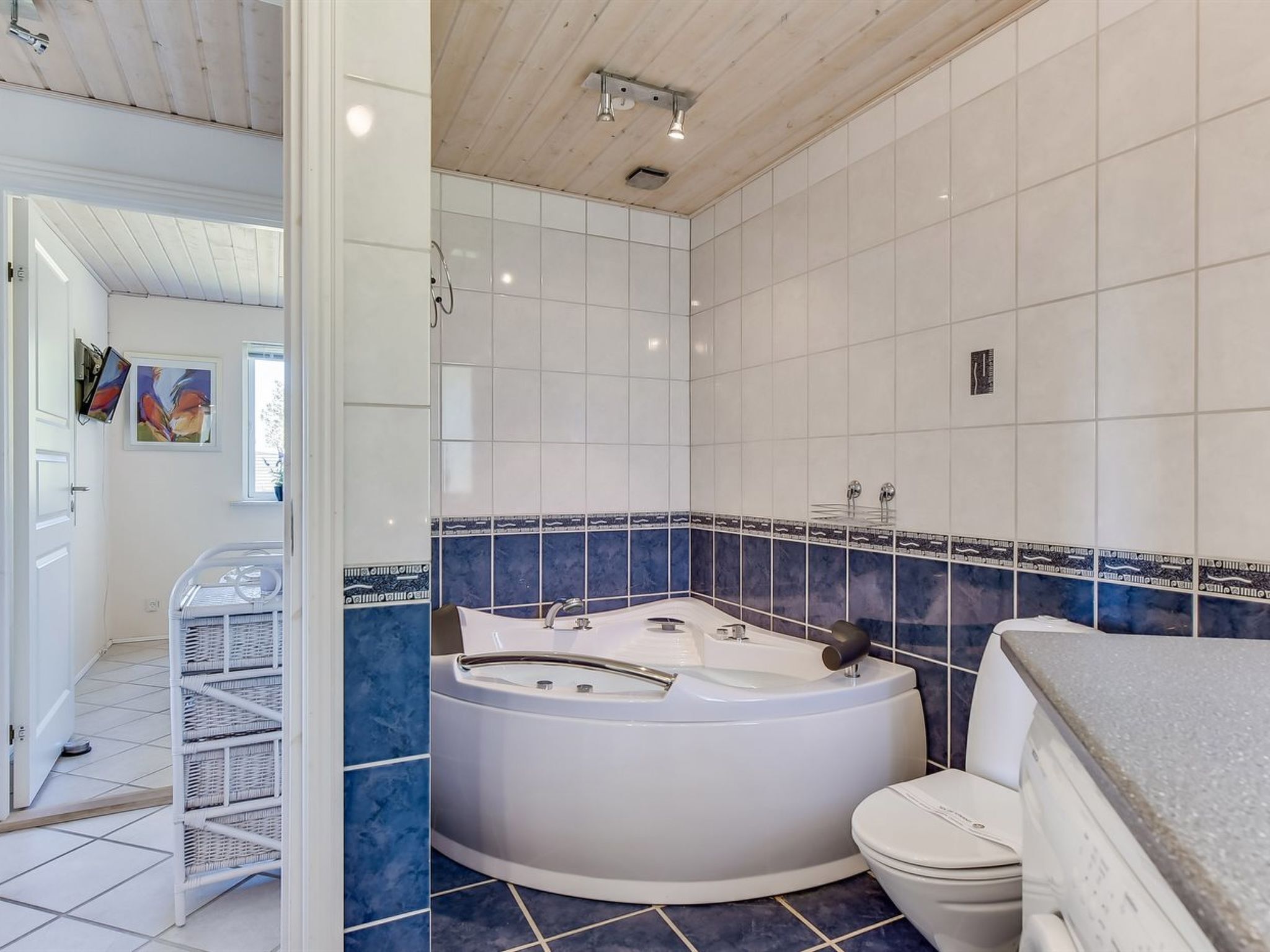A modern bathroom with a freestanding bathtub, a toilet, and a shower area.