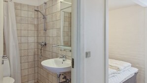 A bathroom with a shower, toilet, and sink. - "Tatianna" - 500m from the sea by Interhome (Rømø)