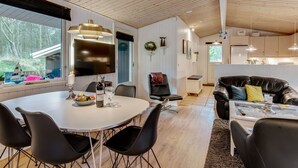 A modern interior with a dining area, living space, and kitchen.