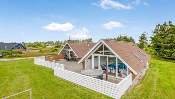 A modern house with a large deck, a hot tub, and a swimming pool. - "Tuomi" - 900m from the sea by Interhome (Ringkøbing)