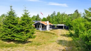 A modern house with a garage, surrounded by dense green trees and a clear sky. - "Andria" - 300m from the sea by Interhome (Hals)