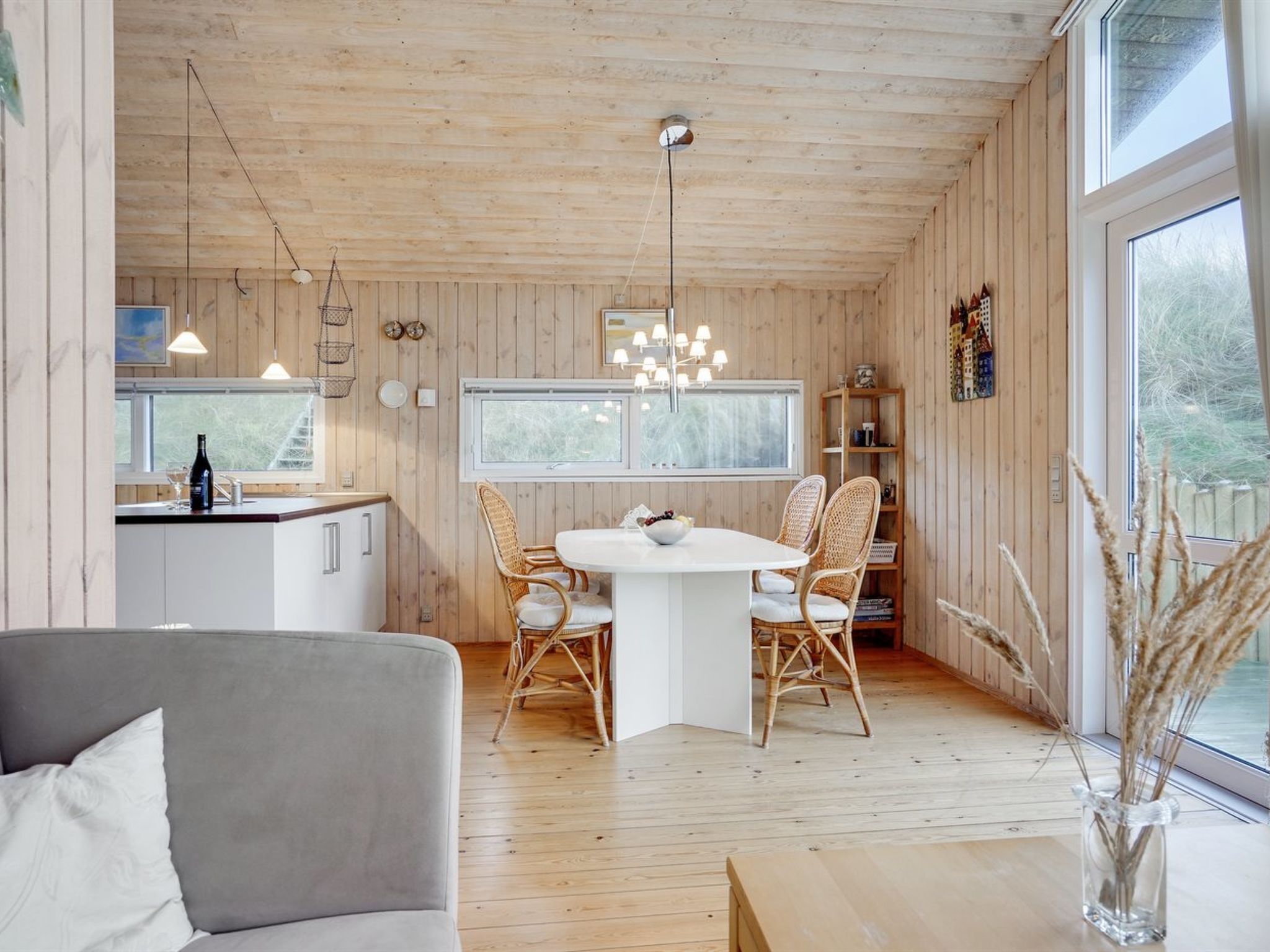 A cozy cabin interior with a dining area, kitchen, and seating space.