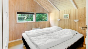 A bedroom with a wooden ceiling, a large bed, two windows, and a picture on the wall. - "Anastaja" - 12km from the sea by Interhome (Oksbøl)