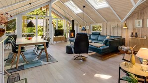 A spacious loft with high ceilings, skylights, a dining area, a living room with a sofa and TV, and a fireplace. - "Anastaja" - 12km from the sea by Interhome (Oksbøl)