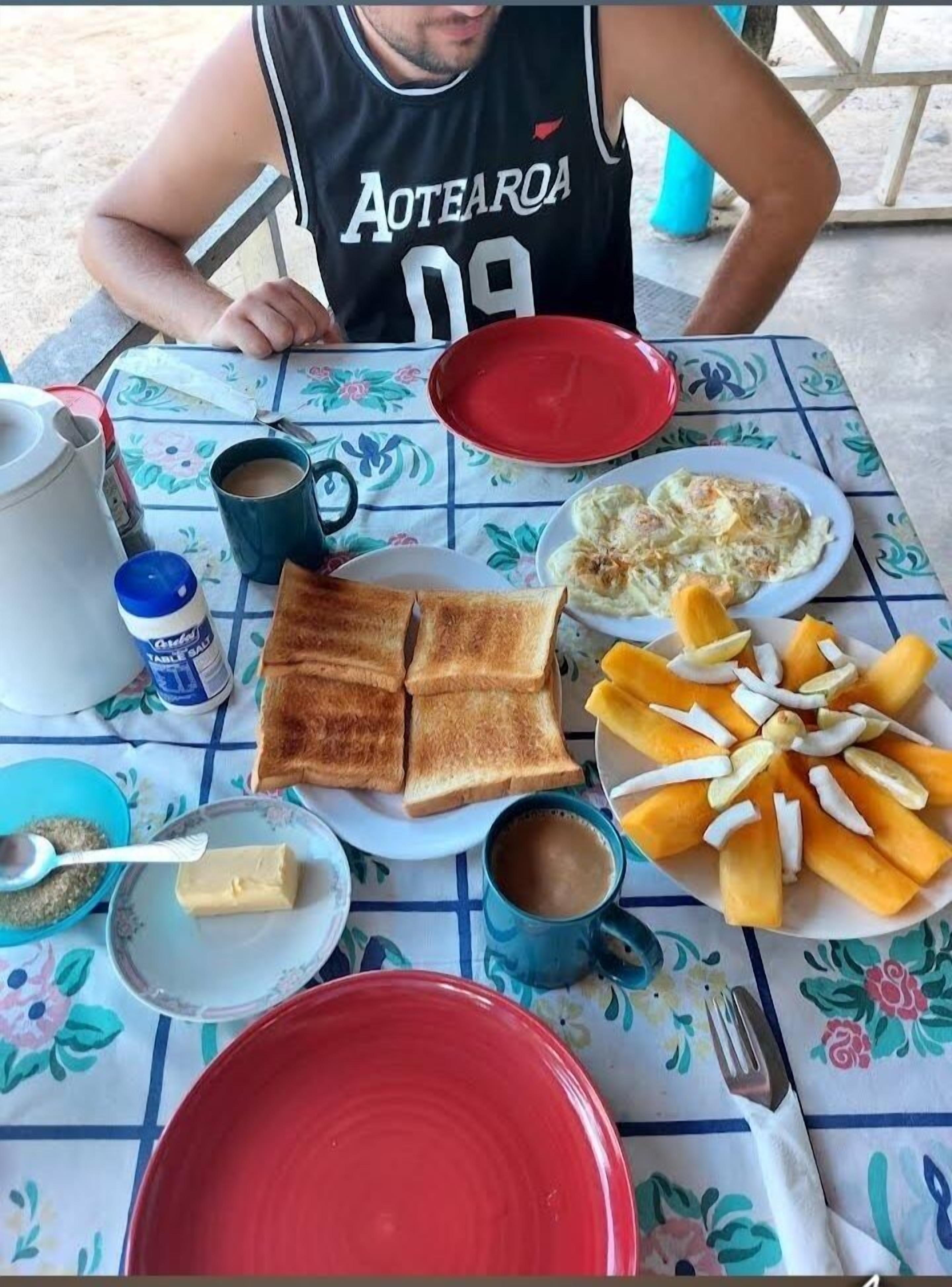 A table with breakfast items including toast, eggs, and fruit.