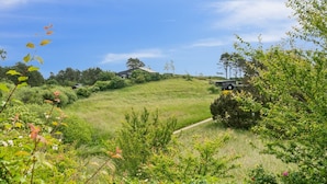 A rural landscape with a house on a hill, surrounded by greenery and a clear sky. - "Arntraud" - 250m from the sea by Interhome (Knebel)