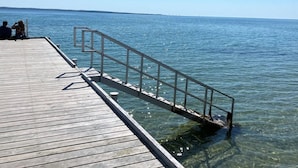 A wooden pier extending into calm water with a metal railing. - "Eva" - 1.5km to the fjord by Interhome (Knebel)