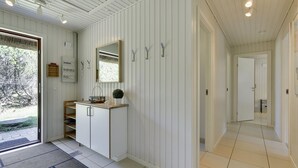A modern kitchen with white cabinetry, a built-in oven, and a window above the sink. - "Satzur" - 800m from the sea by Interhome (Blåvand)