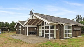 A wooden building with a sloped roof, large windows, and a satellite dish. - "Calina" - 300m from the sea by Interhome (Sæby)