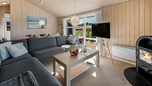 A modern living room with a sofa, coffee table, and a fireplace.