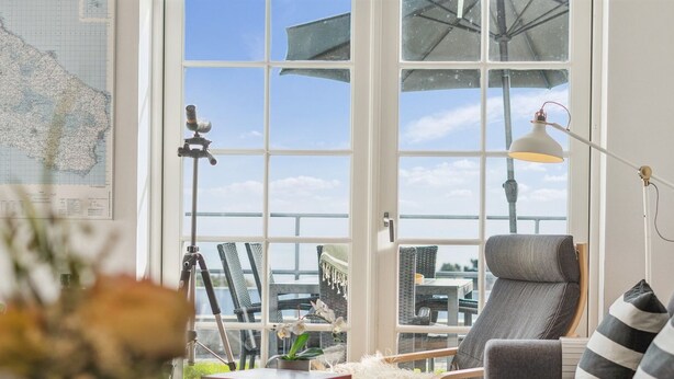 A modern living room with a large window, a telescope, and a view of the outdoors. - "Seba" - 500m from the sea by Interhome (Allinge)