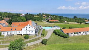 A coastal property with a large white building, a swimming pool, and a view of the sea. - "Seba" - 500m from the sea by Interhome (Allinge)
