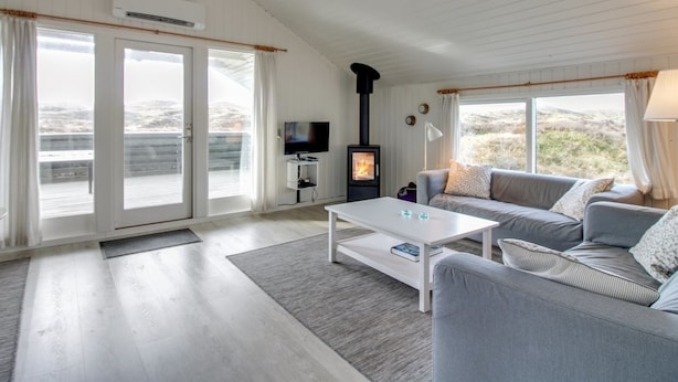 A modern living room with a sofa, a coffee table, a TV, and a wood-burning stove. - "Lilja" - 1.5km from the sea by Interhome (Fanø)