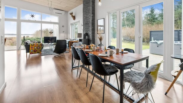 A spacious dining area with a large table, black chairs, and a modern chandelier. - "Tenna" - 250m to the fjord by Interhome (Højslev)