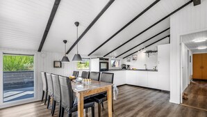 A modern kitchen with white cabinets, a wooden countertop, and a built-in oven. - "Teoline" - 500m to the fjord by Interhome (Hvide Sande)