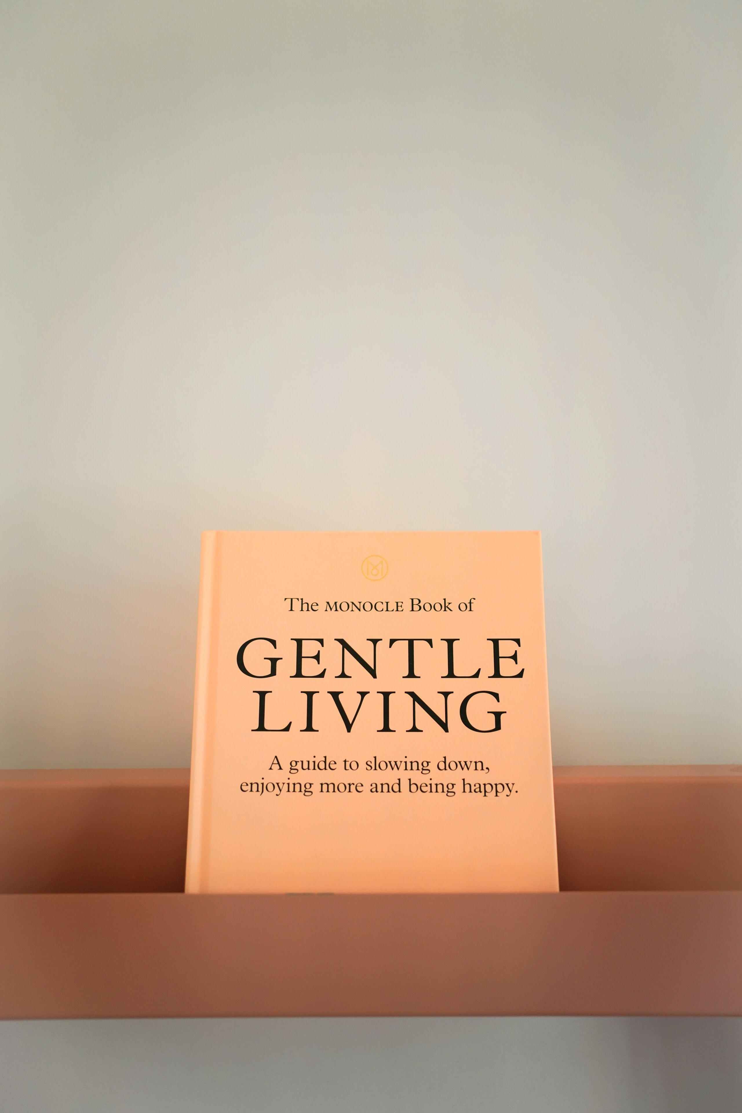 A book titled "The Monocle Book of Gentle Living" in a brown box.