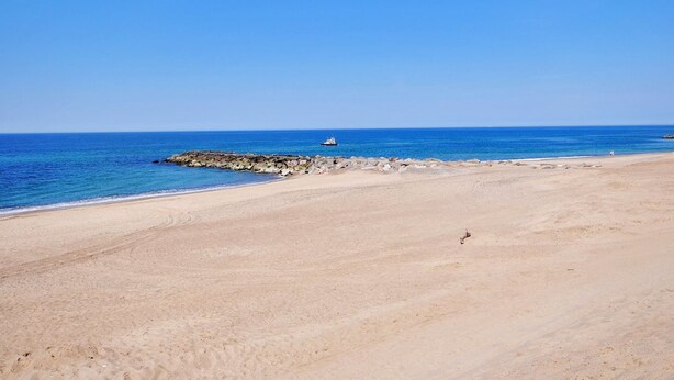 A wide sandy beach with a rocky breakwater and calm blue waters. - "Tofan" - 100m to the fjord by Interhome (Vestervig)