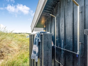 A rustic wooden building with a visible window and a metal pipe extending from the side. - "Rauli" - 50m from the sea by Interhome (Saltum)