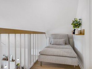 A minimalist room with a white railing, a bench, and a shelf with a plant. - "Thoran" -  from the sea by Interhome (Blåvand)
