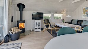 A cozy living room with a wood-burning stove, a television, and comfortable seating. - "Herbert" - 1km from the sea by Interhome (Humble)