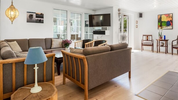 A modern living room with a sofa, chairs, a TV, and a dining area. - "Taralyn" - 1.3km from the sea by Interhome (Væggerløse)