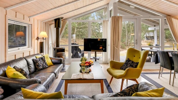 A modern living room with a fireplace, leather sofas, a coffee table, and a TV. - "Abiorn" - 2.5km from the sea by Interhome (Blåvand)