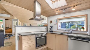 A modern kitchen with a skylight, stainless steel appliances, and a window with a view. - "Enid" - 700m from the sea by Interhome (Væggerløse)