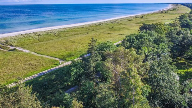 A coastal landscape with a beach, grassy fields, and a road. - "Borica" - 100m from the sea by Interhome (Væggerløse)
