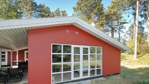 A red building with a large window and a covered patio area. - "Borica" - 100m from the sea by Interhome (Væggerløse)