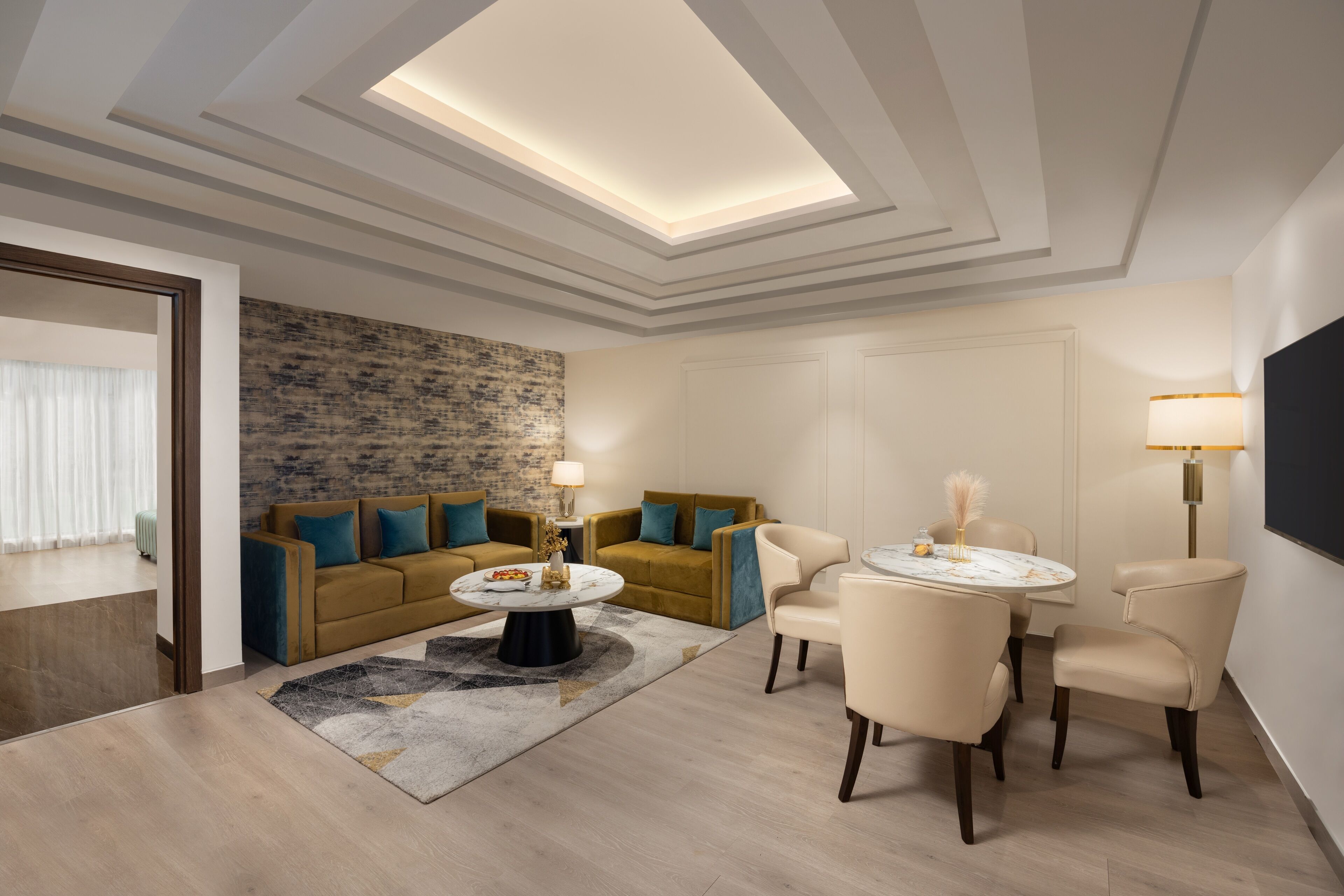 A modern living room with a sofa set, a coffee table, and a dining area with chairs.
