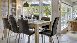 En matplats med ett träbord, svarta stolar och utsikt över omgivningen.