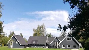 A large, modern building with a flat roof, multiple windows, and a grassy lawn in front. - "Ingalil" - 650m from the sea by Interhome (Væggerløse)