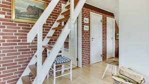 A staircase with white railings and wooden steps leading to a door. - "Dordi" - 300m from the sea by Interhome (Fanø)