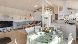 A modern, well-lit living area with a dining table set for breakfast, a sofa, and a television in the background. - "Ferdine" - 1.5km from the sea by Interhome (Fanø)