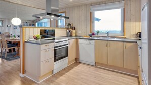 A modern kitchen with wooden cabinets, a built-in oven, and a dishwasher.