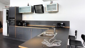 A modern kitchen with a central island, built-in appliances, and pendant lighting. - "Bjerne" - 200m from the sea by Interhome (Rødvig Stevns)