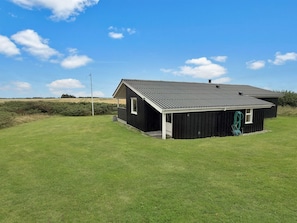 A single-story building with a sloped roof, a small porch, and a visible hose reel. - "Steffenie" - 400m from the sea by Interhome (Løkken)
